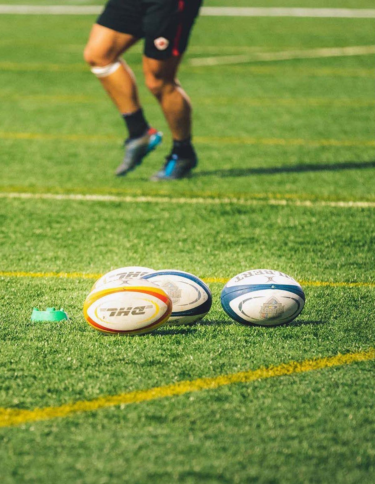 An athlete running an agility drill on a turf surface